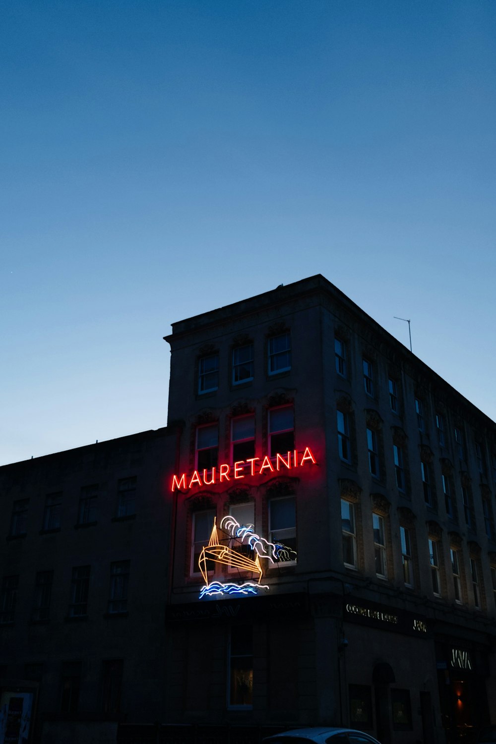 a large building with a neon sign on the side of it