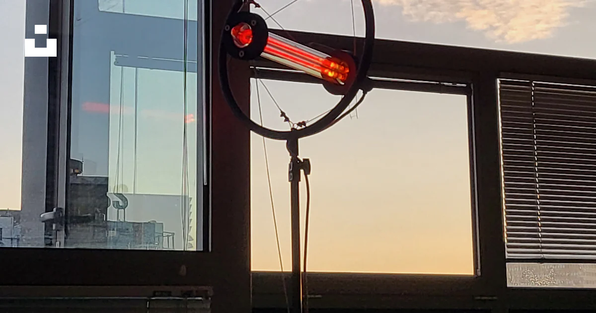 A wind indicator sitting in front of a window photo – Free Art Image on ...