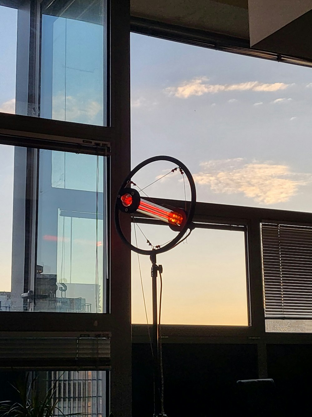 a wind indicator sitting in front of a window