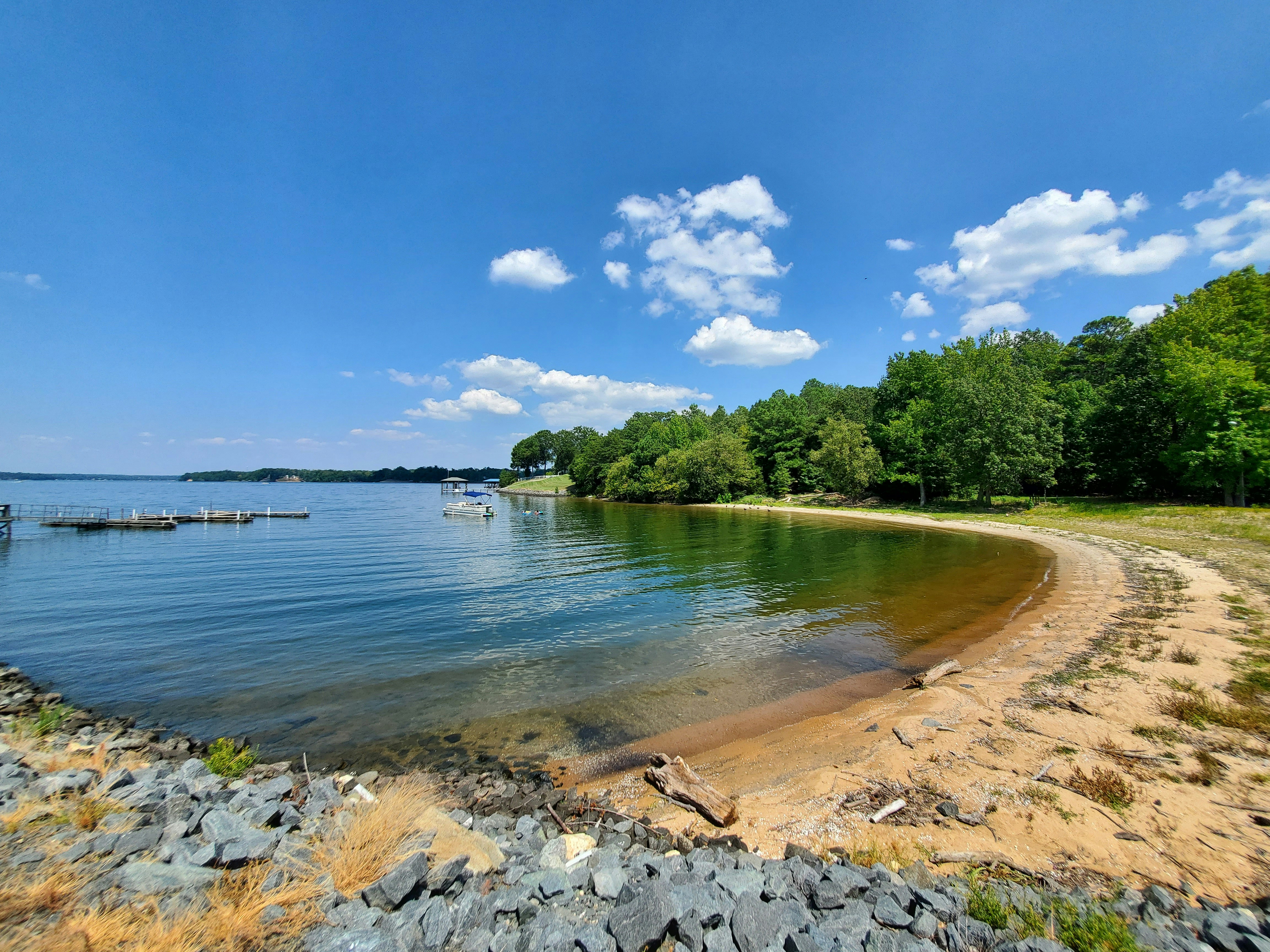 a sandy beach with boats on the water