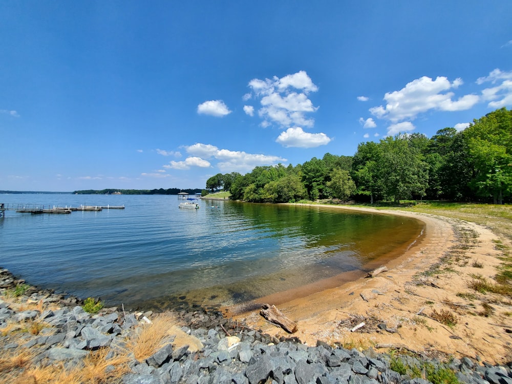 a sandy beach with boats on the water