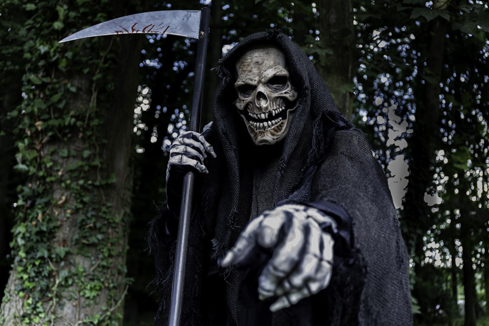 a man dressed in a skeleton costume holding an axe