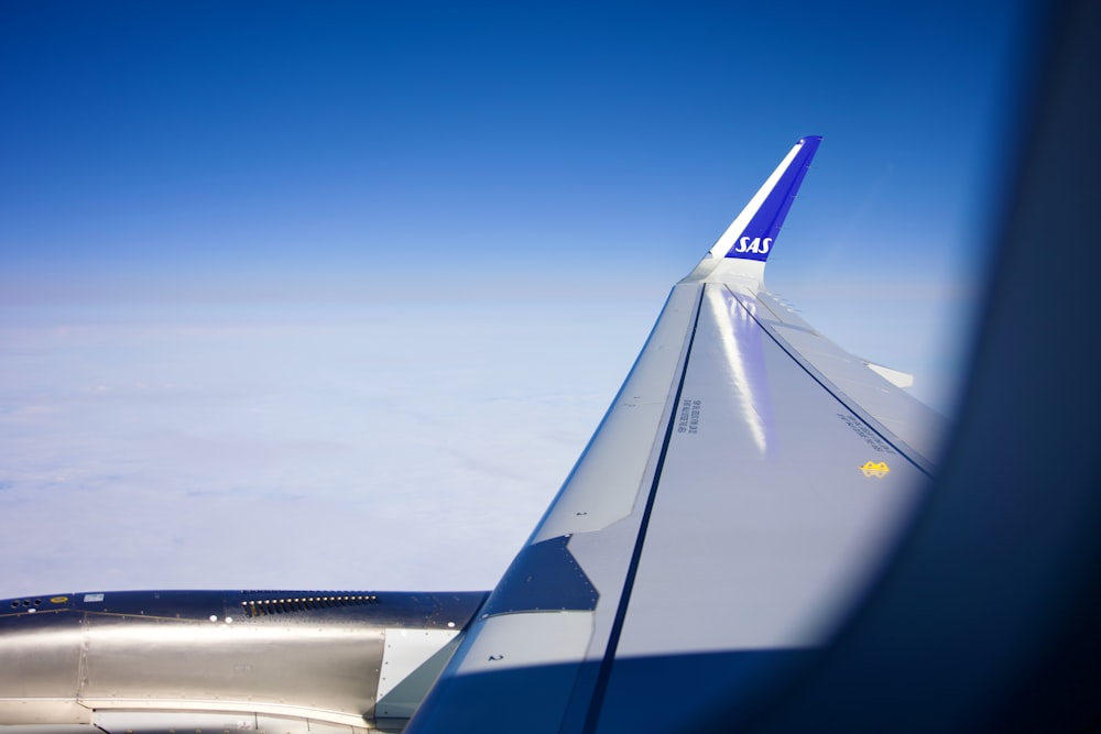 a view of the wing of an airplane in the sky