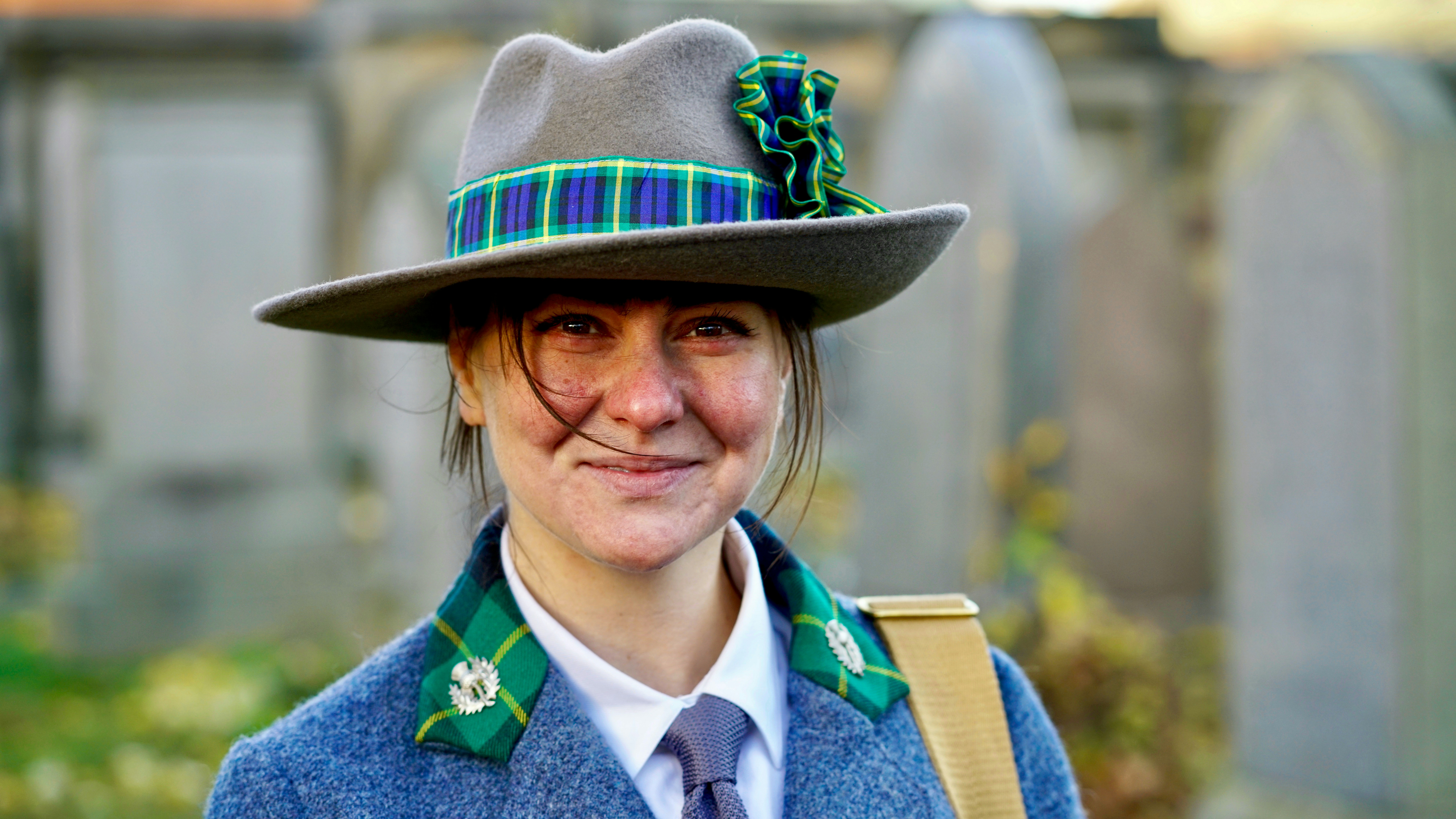 a woman wearing a hat and a blue coat