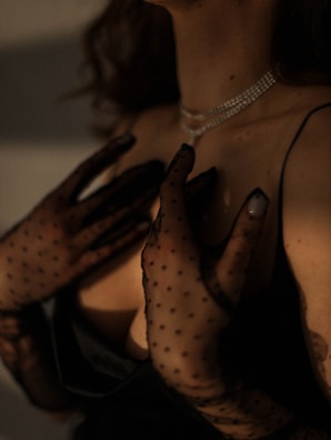 Elegant black gloves laid out next to a delicate scarf.