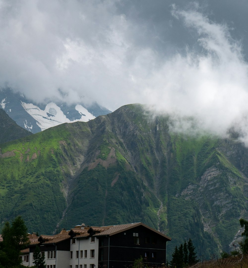 a mountain range with a house in the foreground