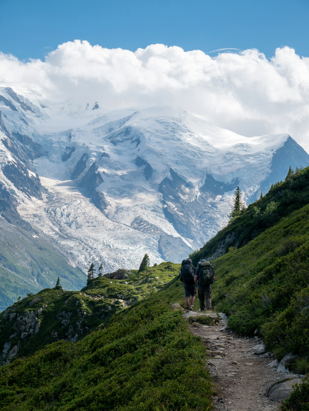 a couple of people walking up a hill