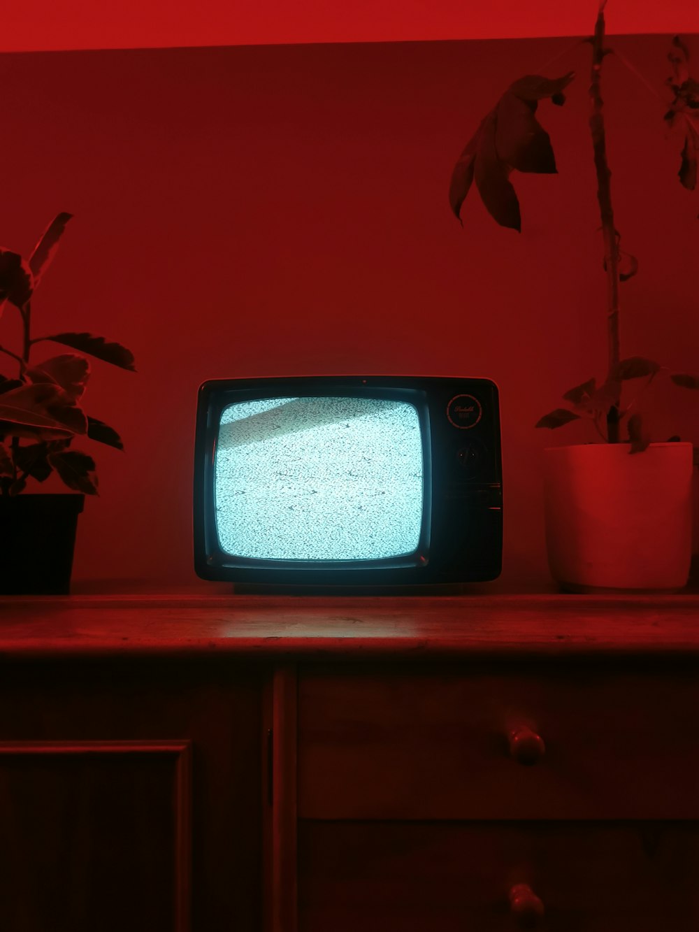 a small television sitting on top of a wooden dresser