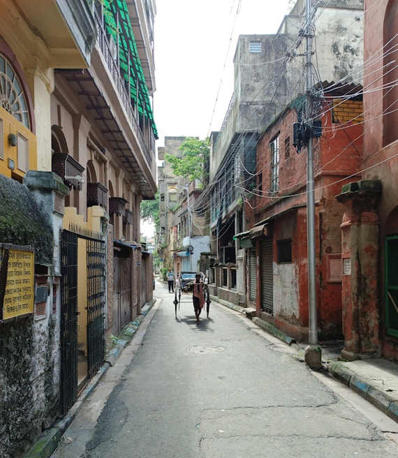 An old street in Calcutta lined with faded murals and vintage street lamps, capturing the city's historic charm.
