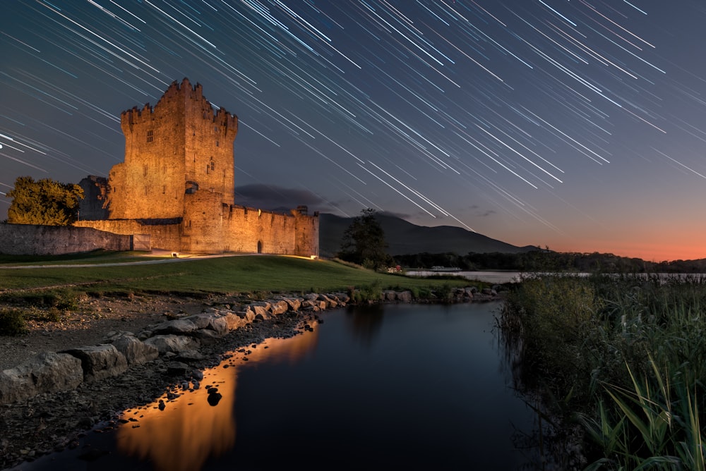 a castle with a lake in front of it at night