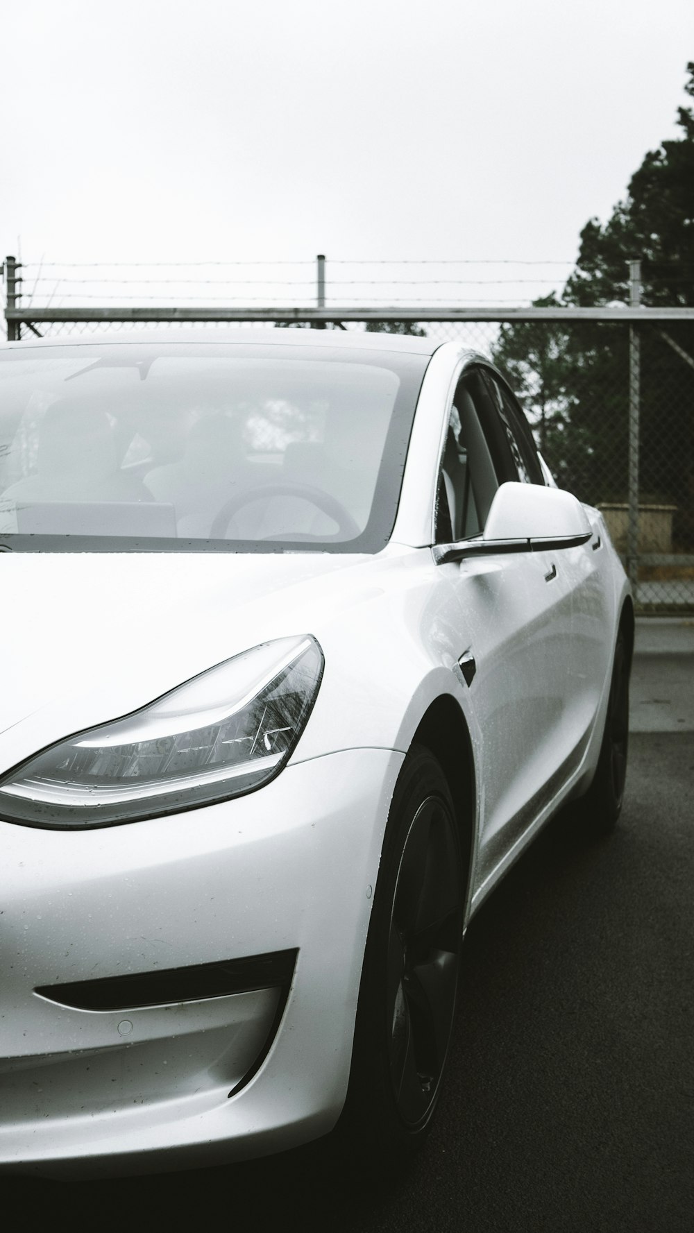 a white tesla parked in a parking lot