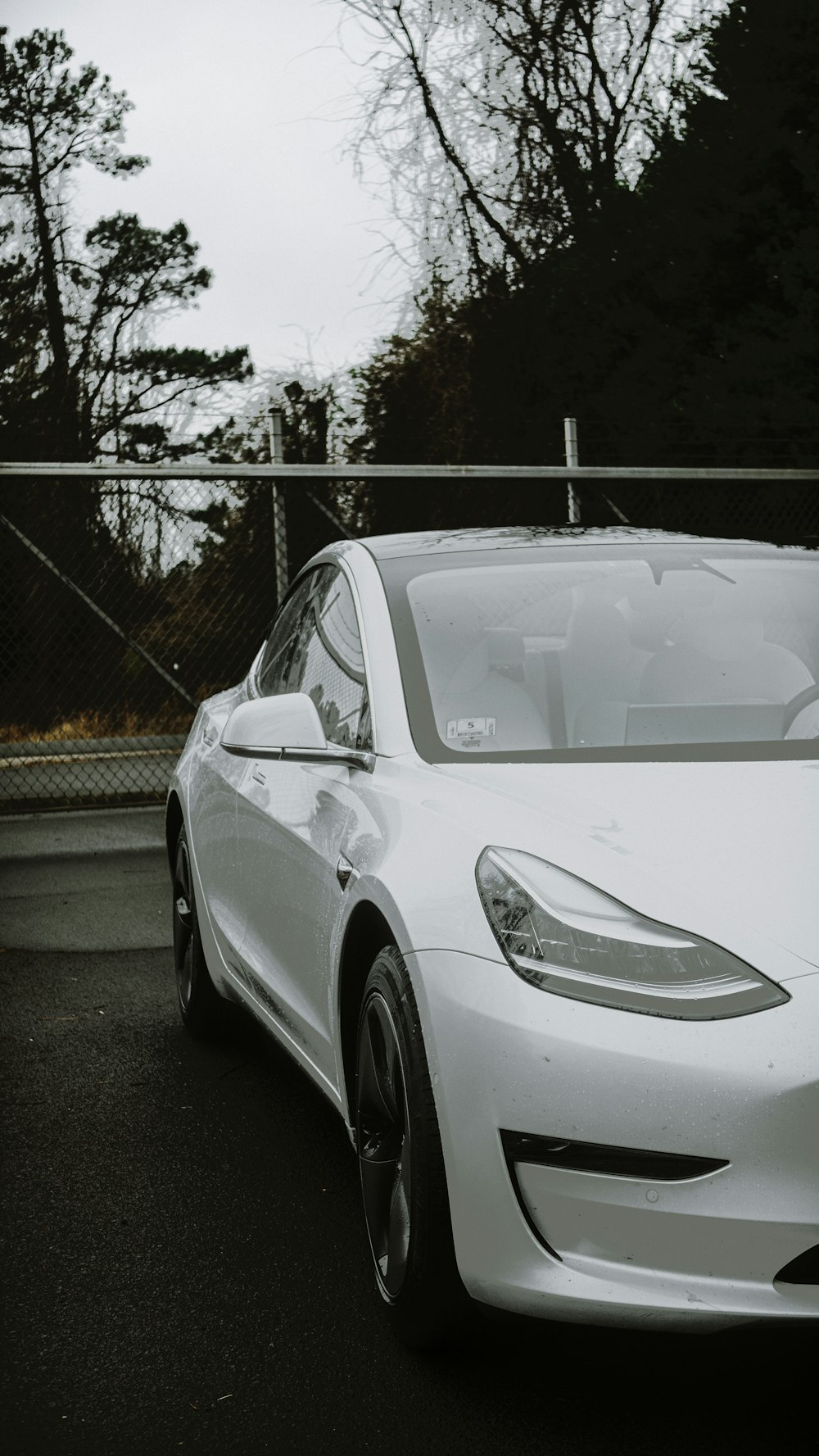 a white tesla parked in a parking lot