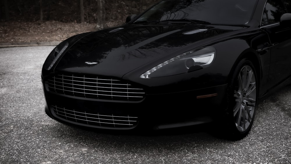 a black sports car parked in a parking lot