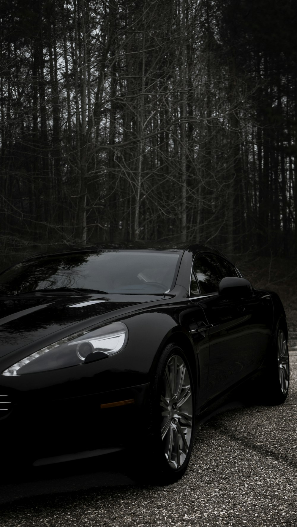 a black sports car parked in a parking lot