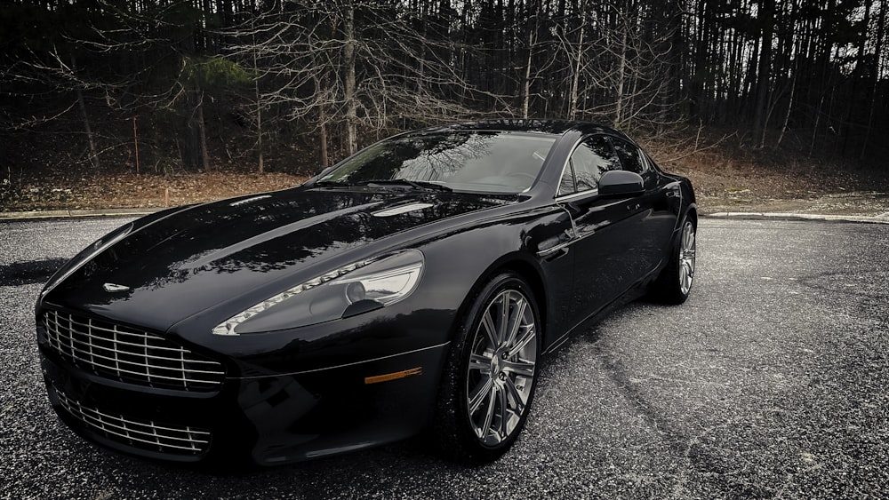 a black sports car parked in a parking lot