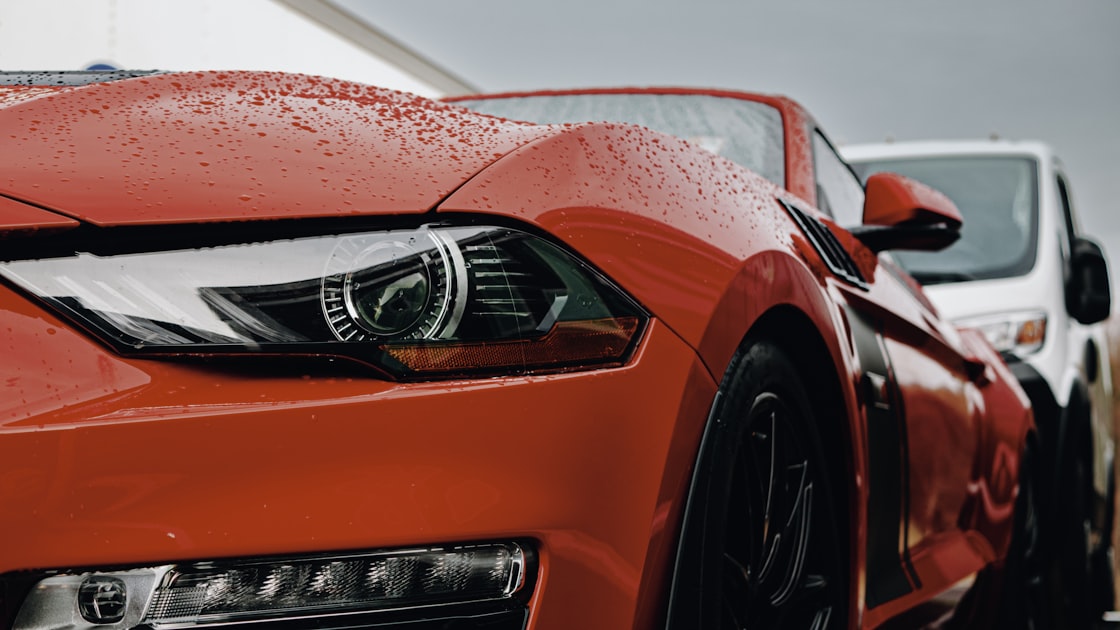 a close up of the front of a red sports car