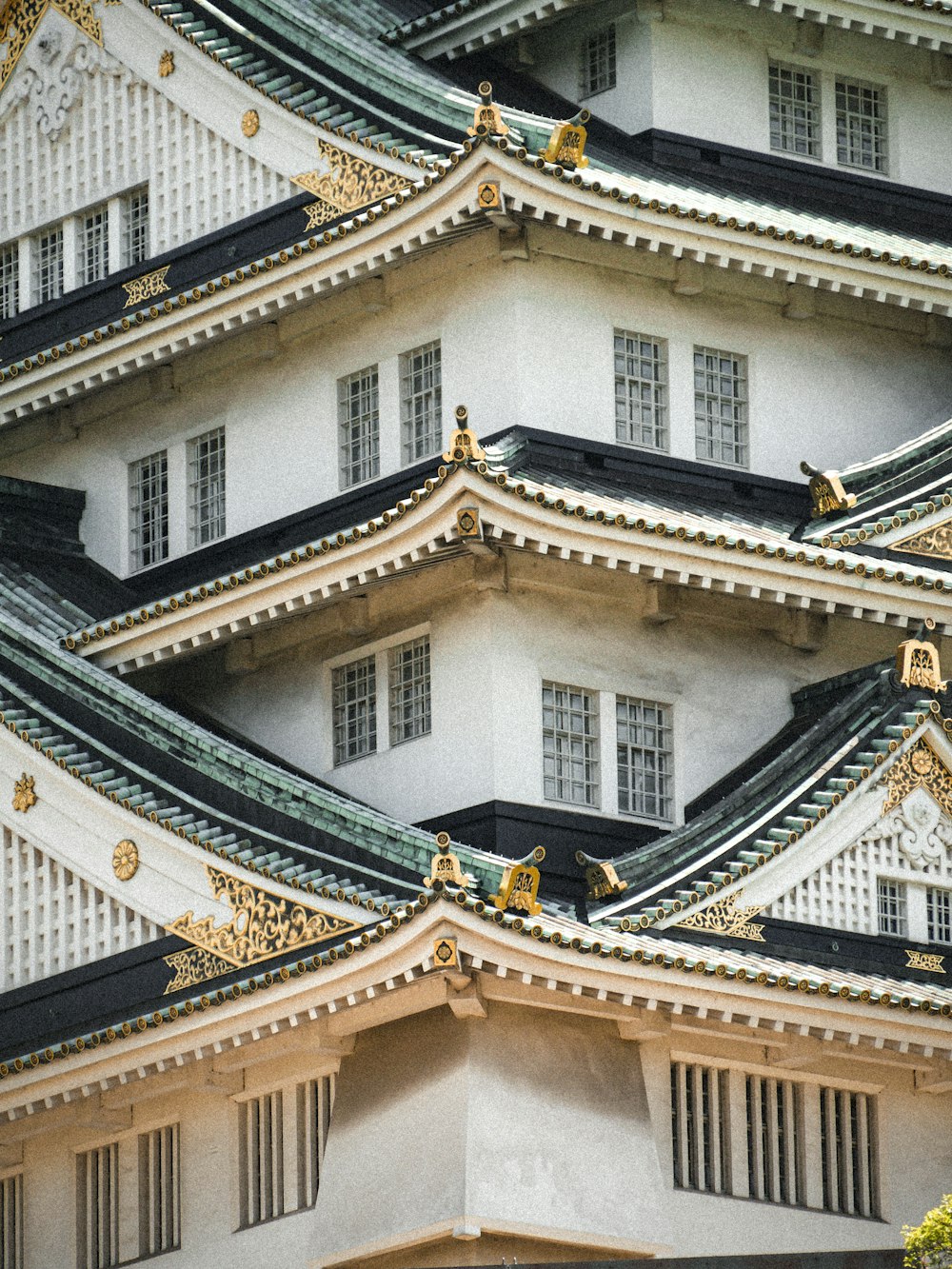 a large white building with a black roof