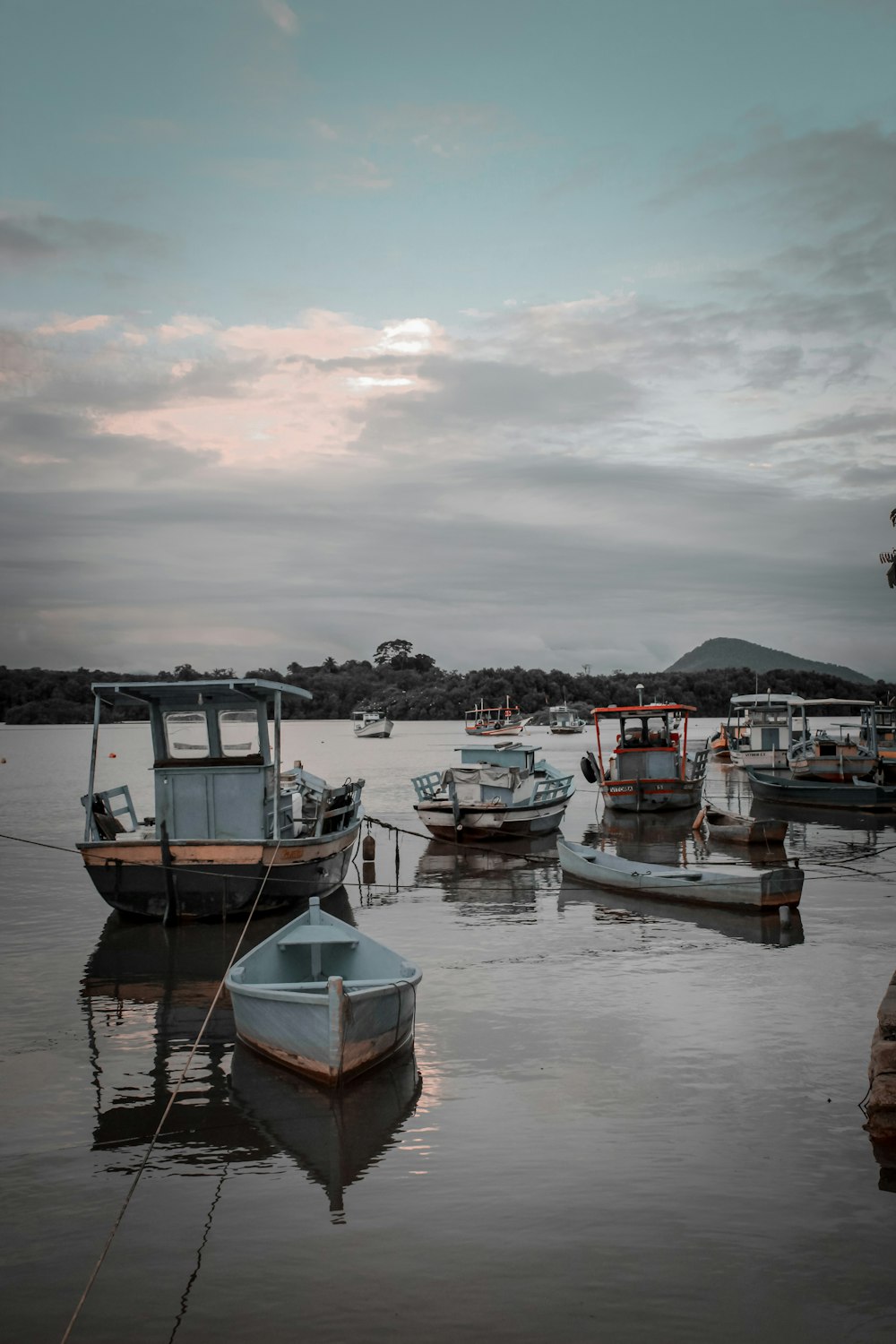 a group of boats floating on top of a lake