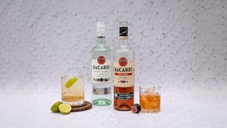 two bottles of alcohol sitting next to each other