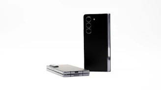 Close-up of sleek, modern smartphones displayed on a polished surface.