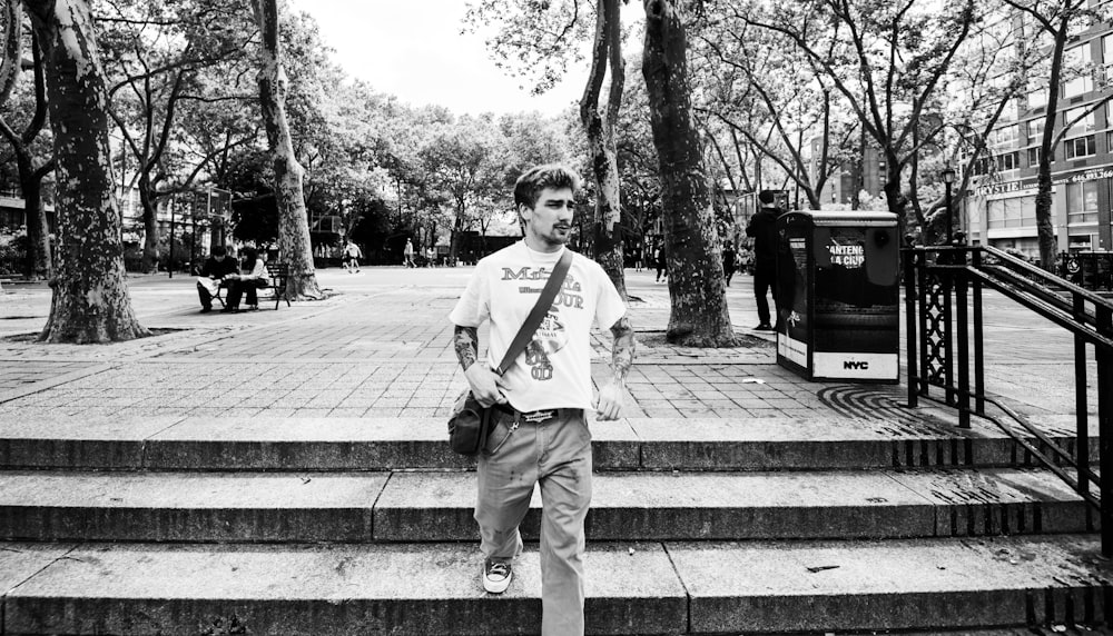 a man standing on the steps of a park