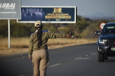 a woman on a skateboard on the side of the road