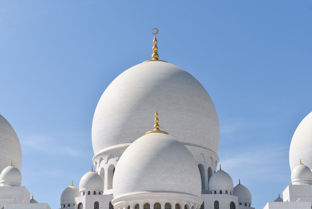 a large white building with three domes on top of it