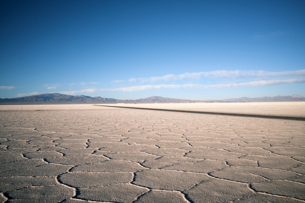 a vast expanse of flat land with mountains in the distance