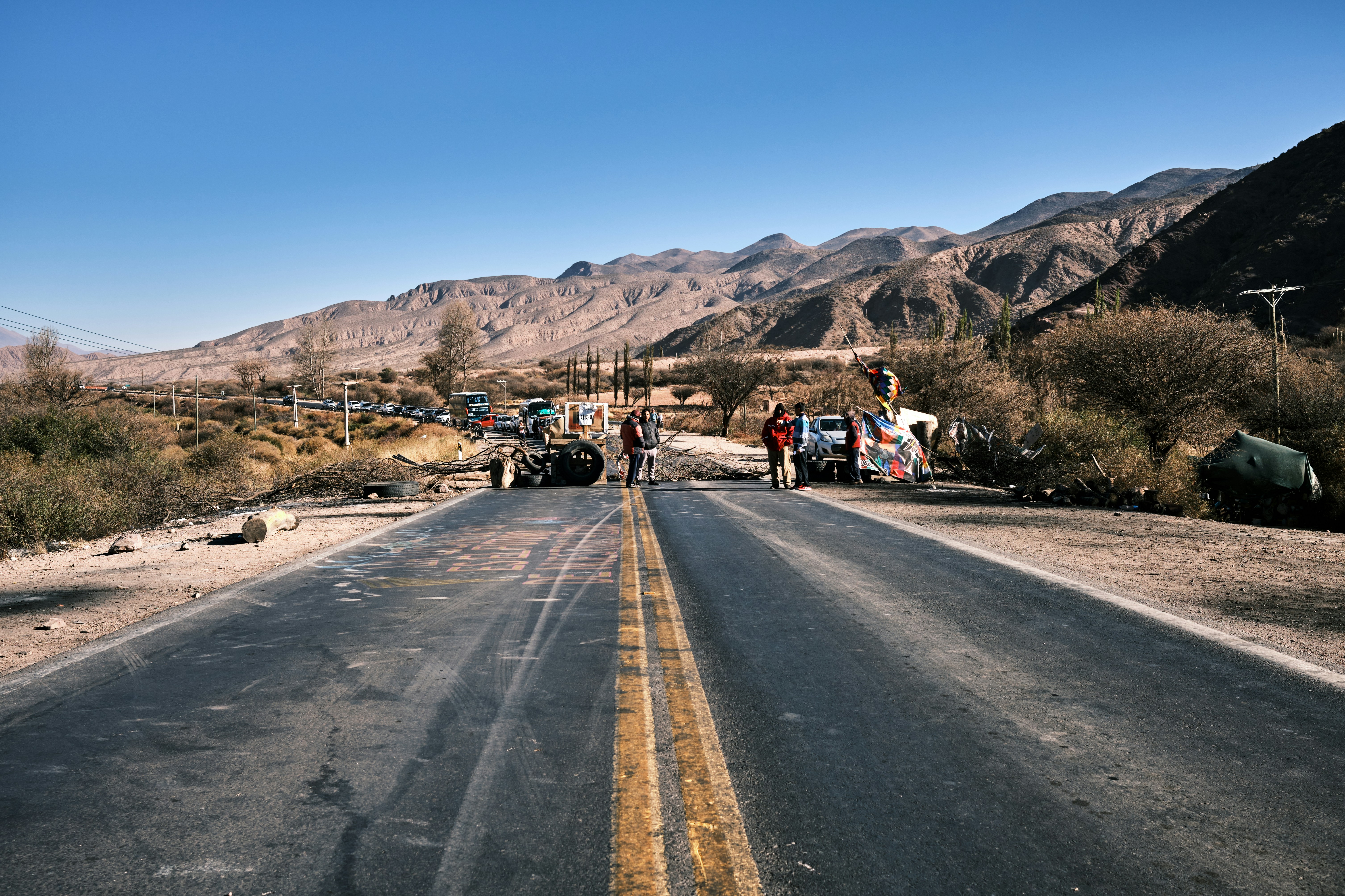 a couple of people standing on the side of a road