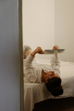 A person reading an ebook on a tablet in a minimalist, bright room.