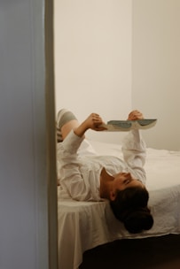 A person reading an ebook on a tablet in a minimalist, bright room.