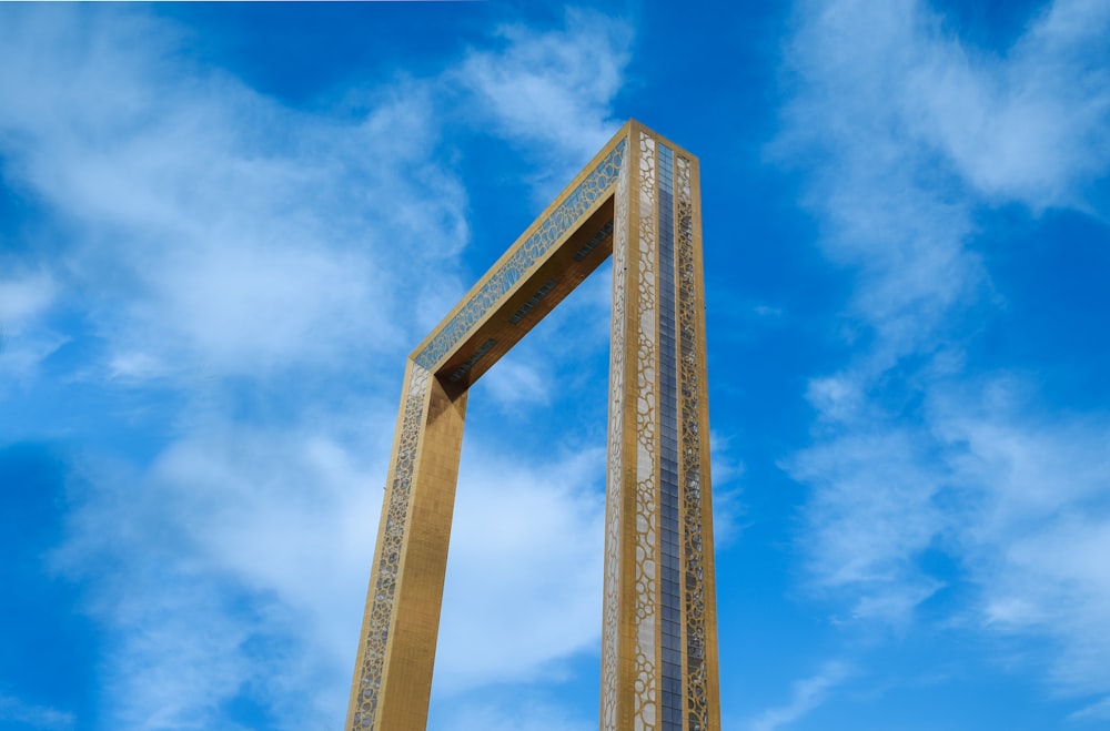a tall wooden structure with a sky background