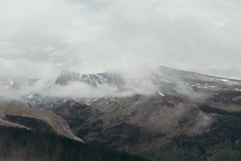 a view of a mountain range covered in clouds