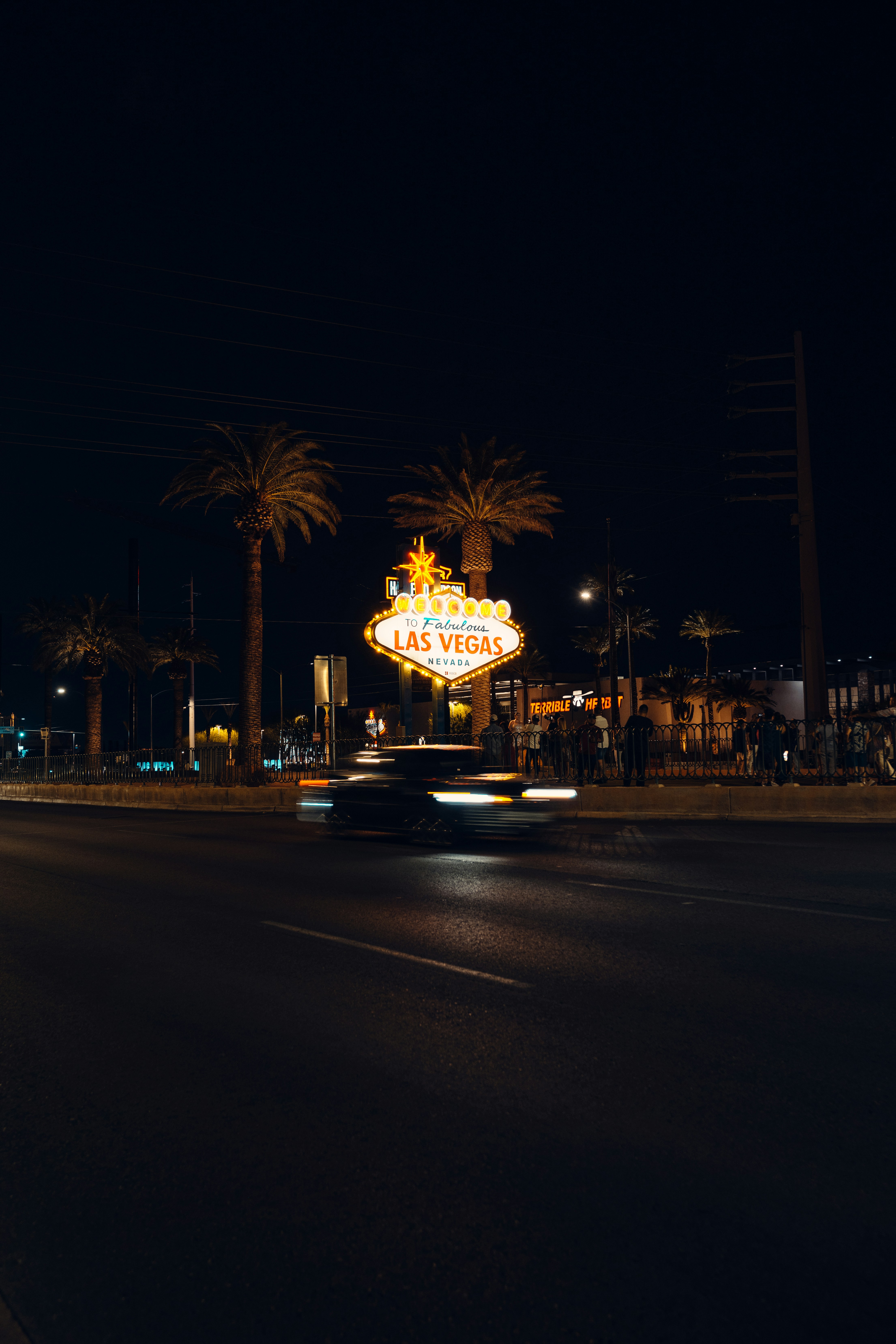 a car driving down a street at night