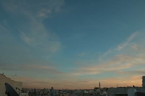 Al-Garran's towering cityscape under a twilight sky.