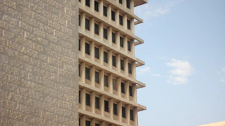 A multi-story RCC building rising against a clear sky, showcasing solid construction.