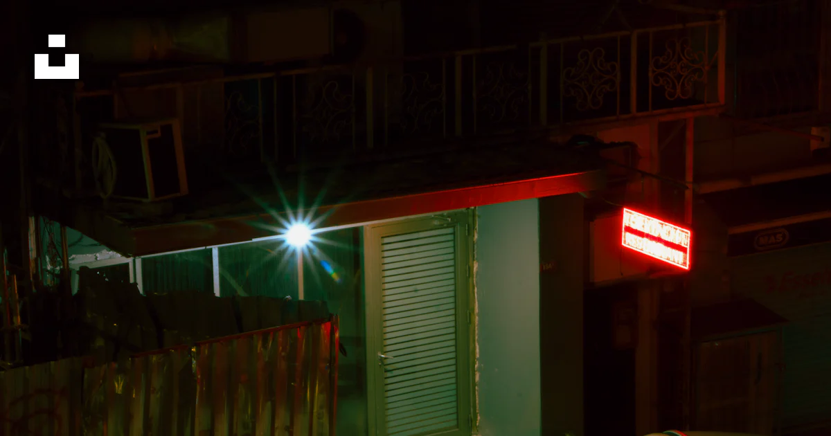 A building with a red light at night photo – Free Building Image on ...