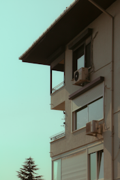 Modern residential building with an outdoor air conditioning unit installed.