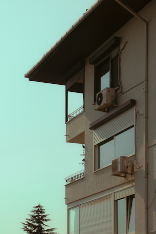 A technician installing an air conditioning unit in a modern office.