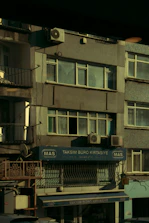 Close-up of hands signing official tax documents with a backdrop of Istanbul’s skyline.