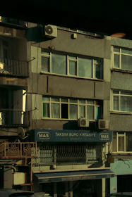 Close-up of hands signing official tax documents with a backdrop of Istanbul’s skyline.