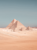 The majestic pyramids of Giza standing tall under a clear blue sky.