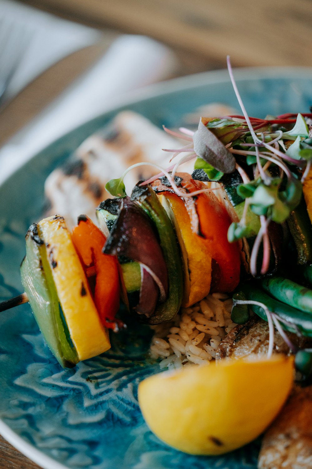 a blue plate topped with meat and veggies