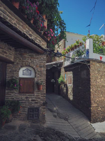 A peaceful path through Toledo's old town, lined with historic walls and quaint shops.