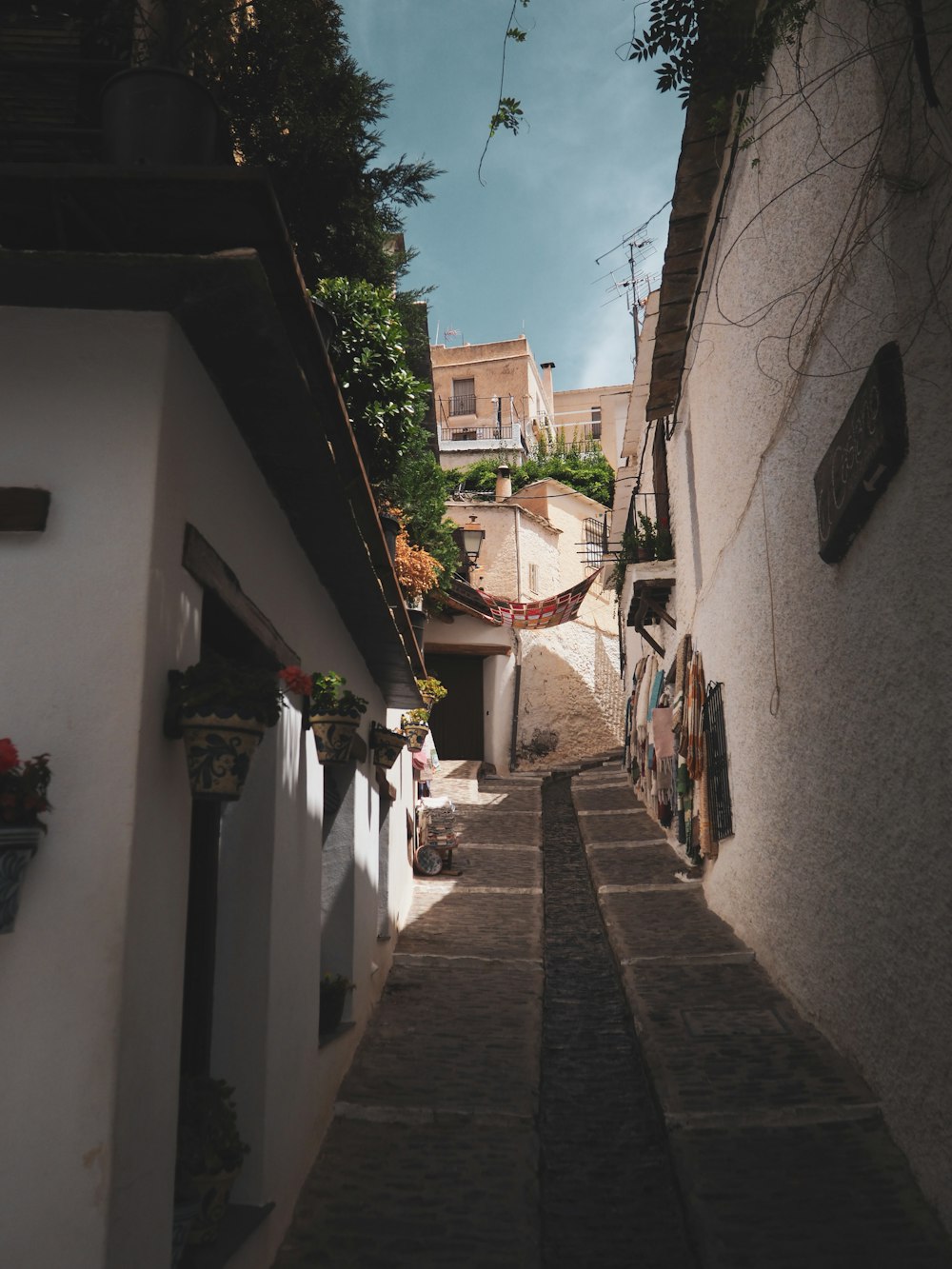 a narrow street with a few buildings on both sides