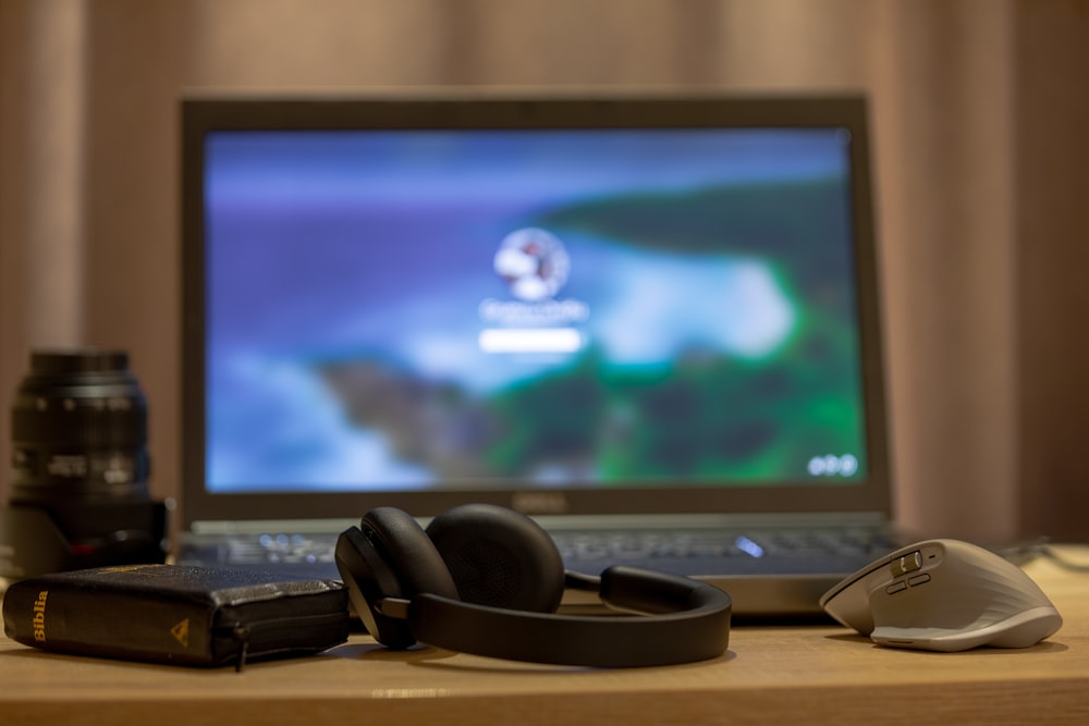 a laptop computer sitting on top of a wooden desk