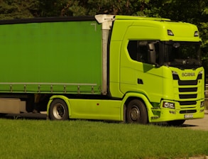 A delivery truck parked in a green landscape, symbolizing eco-friendly logistics.