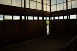 Spacious family room with rustic decor and views of lush greenery outside.