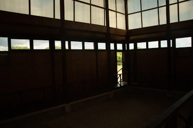 Spacious family room with rustic decor and views of lush greenery outside.