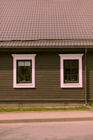 Before and after shots of a home’s exterior renovation highlighting new black trim and siding.